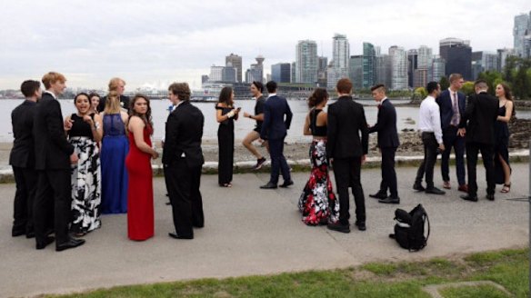 Justin Trudeau jogs past a group of students en route to their school formal.