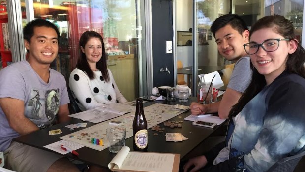  Board game enthusiasts Joshua Teo, Katie Wright, Jared Toe and Samantha Burns were still at Club Sosay fours hours after it opened.
