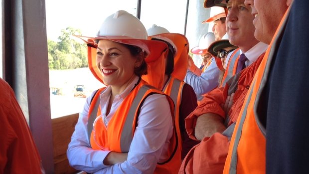 Transport Minister Jackie Trad watches rail being laid at the new Murrumba Downs station.
