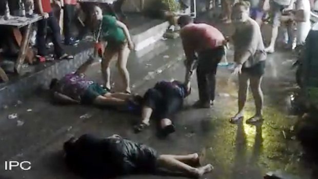 An elderly British couple and their son are on the ground after they were savagely attacked during a family vacation in Hua, Hin, Thailand. 