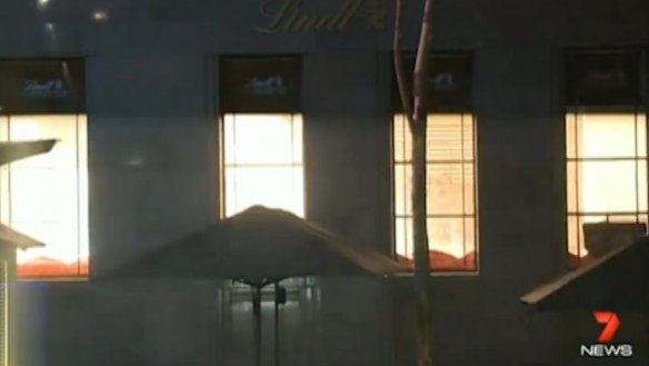 Awful end: The Lindt cafe lights up as police storm the building.