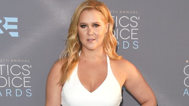No Trainwreck: Amy Schumer opted for a white Calvin Klein halter-neck dress for the 21st Annual Critics' Choice Awards on Sunday in LA.