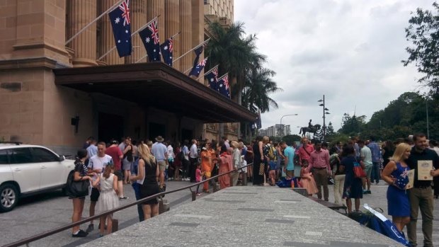 Some of Australia's newest citizens gather outside Brisbane's City Hall.