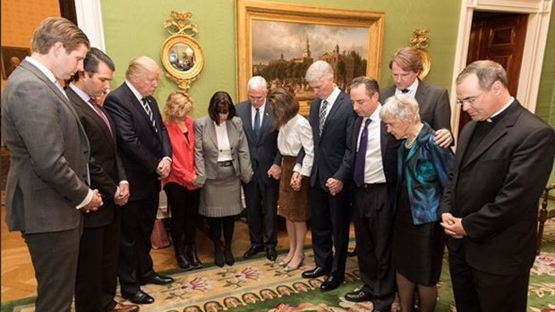 President Trump, third from left, prays with members of his family, his inner circle and Father Paul Scalia, son of late Judge Antonin Scalia after the nomination of Neil Gorsuch, fifth from right, to the Supreme Court.