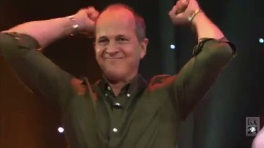 Lost for words, Peter Greste raises his arms in jubilation.