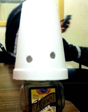 A honey bottle made up to look like a Ku Klux Klan member was allegedly left in the breakroom at BHP's Pinto Mining Group.
