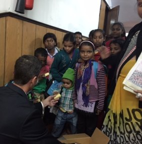 Soap Aid chief executive Michael Matulick hands out recycled soap bar to schoolchildren in the Indian city of Patna.