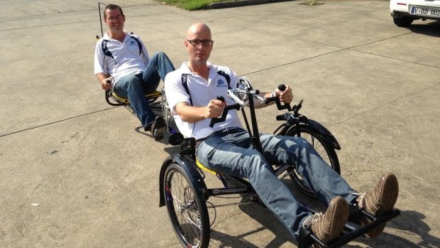 Scott Sullivan rode with his legs while and Ian Davis rode with his hands on their custom made bicycle.