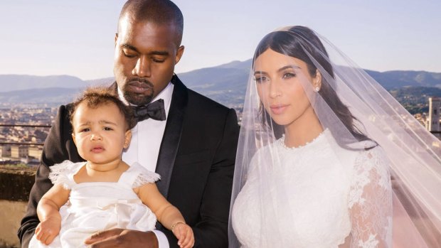 Kardashian West wore Givenchy for her wedding to Kanye West in Florence, Italy, in 2014. Pictured with their daughter, North.