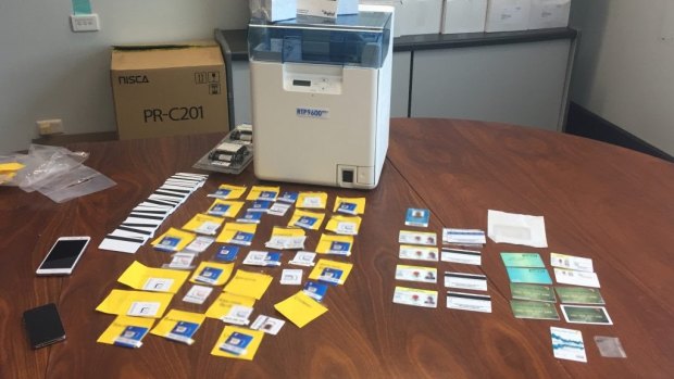 Driver's licences, bank cards, Medicare cards, staff ID cards, mobile phones and sim cards were seized at the Godwin Beach residence.