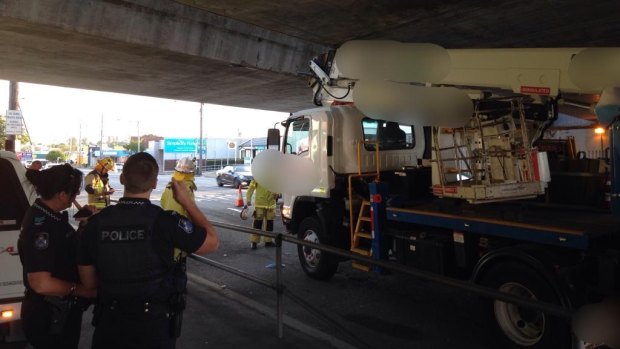 Queensland Rail has warned drivers to check vehicle heights after a rail bridge crash at Woolloongabba