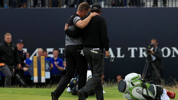 Iconic: Stenson and Mickelson embrace as they leave the Royal Troon course.
