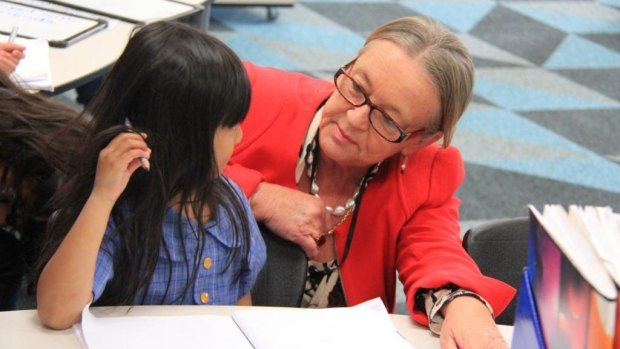 Minister for Education and Training Joy Burch speaks to Annisa Putri, 5, at the newly opened Tuggeranong Introductory English Centre facility at Wanniassa Hills Primary School.