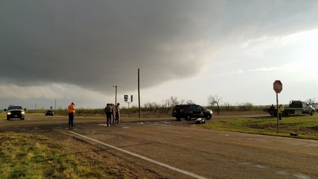 Texas Department of Public Safety troopers investigate a two-vehicle crash that left several storm chasers dead.