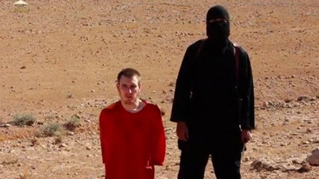 Video clip: Abdul-Rahman Kassig is pictured kneeling beside a masked man in an image released this month.