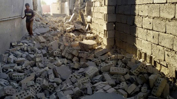 A man walks in the rubble of a damaged house in Fallujah. The city's 100,000 remaining inhabitants will fear a repeat of the liberation of Ramadi, which has reportedly left that city in ruins.