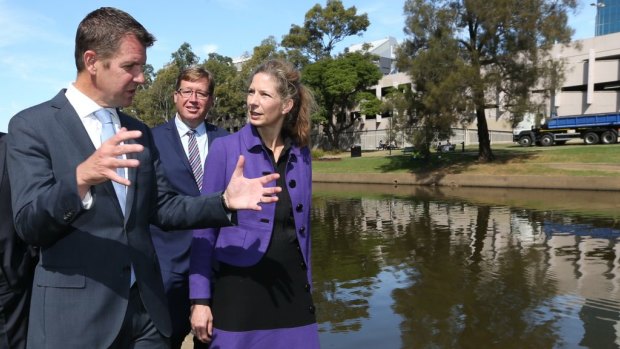 NSW Premier Mike Baird (left), Deputy Premier Troy Grant and newly appointed Powerhouse director Dolla Merrillees walking along Parramatta River across from the proposed museum site.