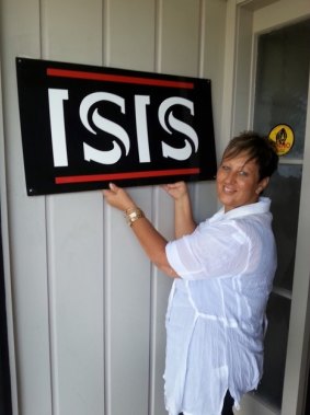 The old ISIS sign is removed from the company's Auckland office by BC Group general manager Carolyn Davies.
