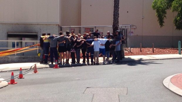 Workmates of Matt Hutchins pay their respects at the Galleria.