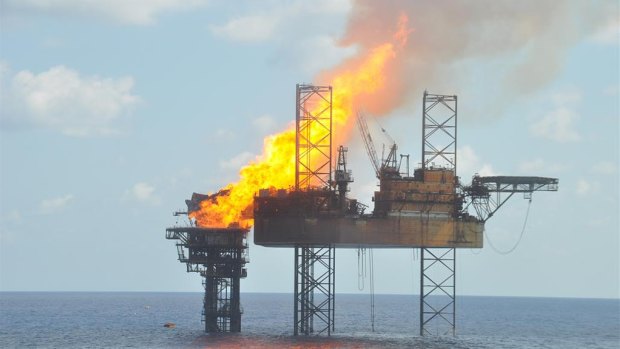 A handout photograph shows a well head platform on fire in the Montara oil field on  November 2, 2009. 