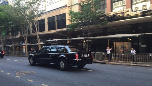 Barack Obama's armoured vehicle, known as The Beast, travels down Adelaide Street in the Brisbane CBD. 