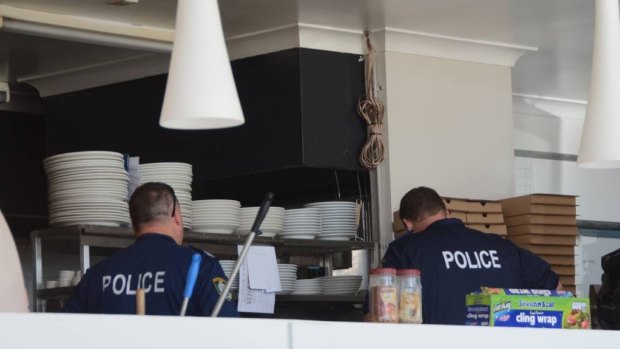 Police search a woodfire pizza business in Ulladulla as part of nine drug raids on the NSW South Coast.