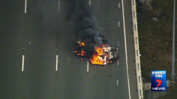 The burning wreckage of the combi van on the M1.
