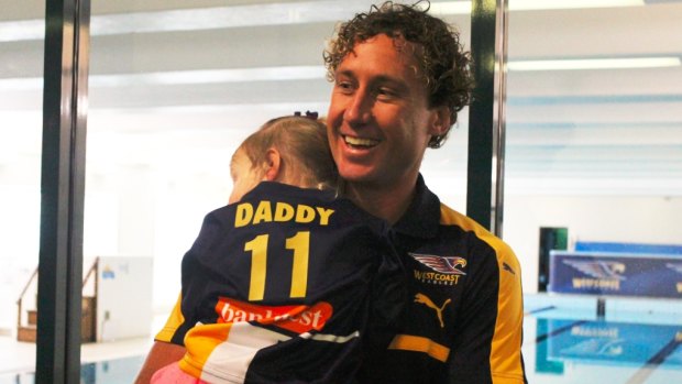 Priddis with his daughter after his press conference to announce his retirement.