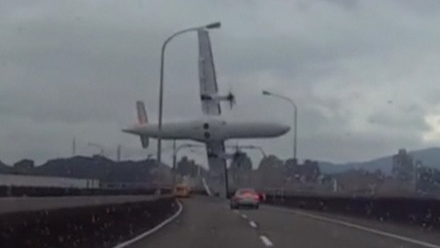 A video shot by a motorist shows a TransAsia Airways plane cartwheeling over a motorway soon after take-off.