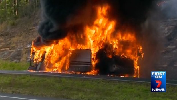 A school bus burns in the northbound lane of the Bruce Highway near Sippy Downs, north of Brisbane.