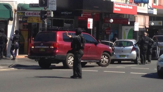 A police officer stops traffic after a grey Toyota (right) was pulled over.