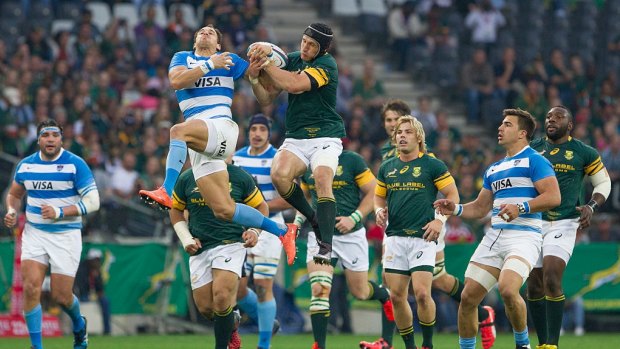 Unconvincing: Springbok Johan Goosen and Joaquin Tuculet of Argentina contest the ball during South Africa's narrow win.