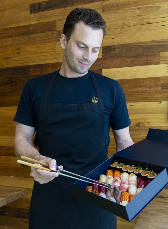 Chef Arnaud Laidebeur with an Uminono omakase box.