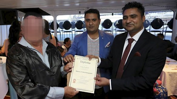 Amarjit Khela presents one of his students with a diploma.