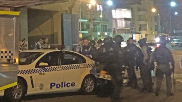 Police gather outside the apartment in North Bondi.