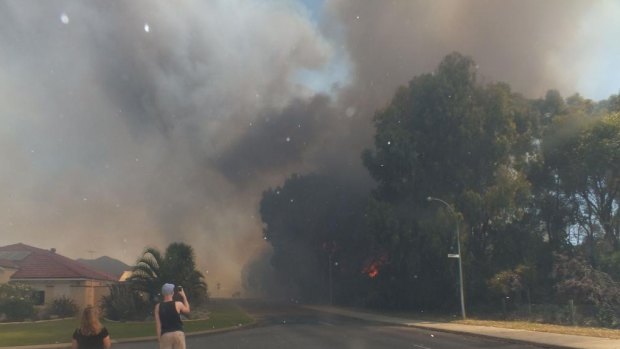 A bushfire burns close to homes on Fisher Street in Rockingham.