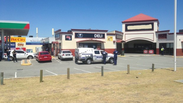 Police arrive outside a deli to find a suspected armed robber 
