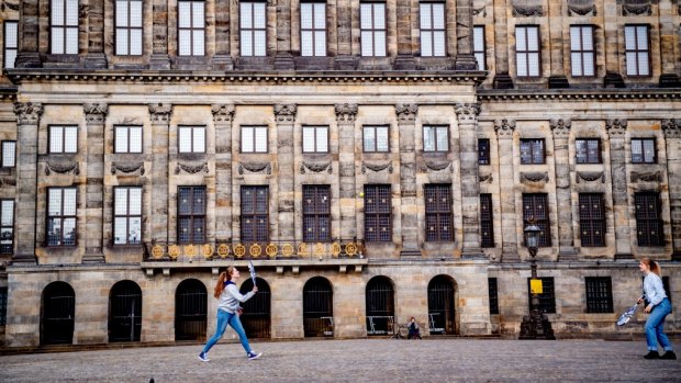 Girls play badminton in Dam Square.