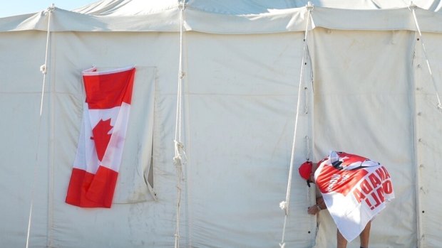 Canadian Modar Safar of Gilbert, Ontario ties closed his tent.