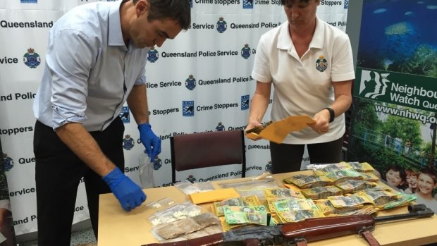 Police seized drugs, cash and drugs in a raid on a Cairns property.