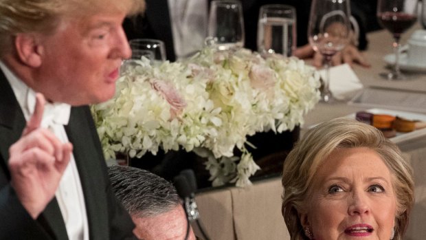 Hillary Clinton and Cardinal Timothy Dolan, Archbishop of New York,  listen as Donald Trump speaks at the Alfred E. Smith Memorial Foundation Dinner in New York on Thursday.