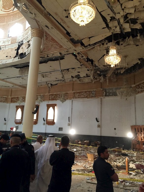 Police inspect the mosque after the explosion.