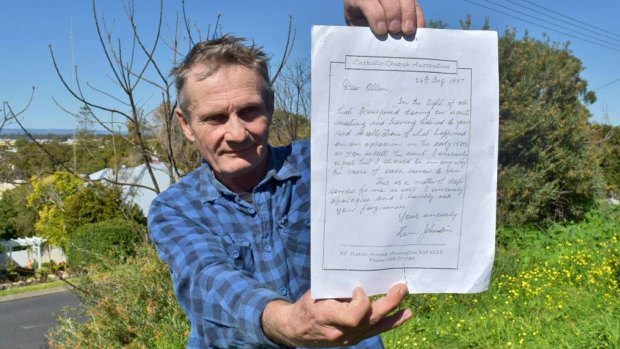 Alan Rowe holding a handwritten letter from the priest he accuses of abusing him in the 1970s that asks for forgiveness. 