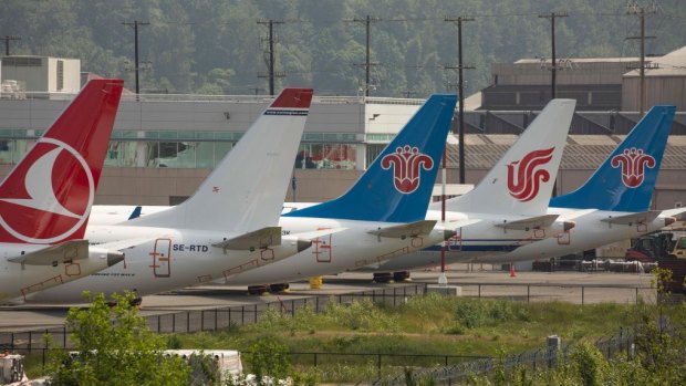 The tails of grounded Boeing 737 MAX airplanes parked at a Boeing facility in Washington State.