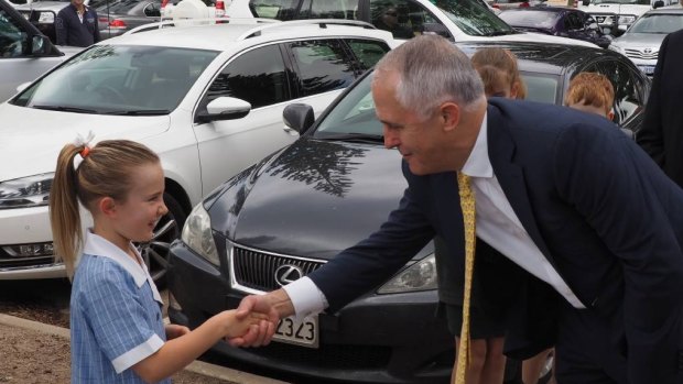 Our Lady Star of the Sea primary school student Stella Wildberger shakes hands with Prime Minister Malcolm Turnbull.