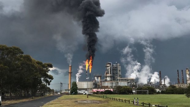 Smoke billowing from the Altona refinery as a storm rolls into Melbourne on Friday, November 17.