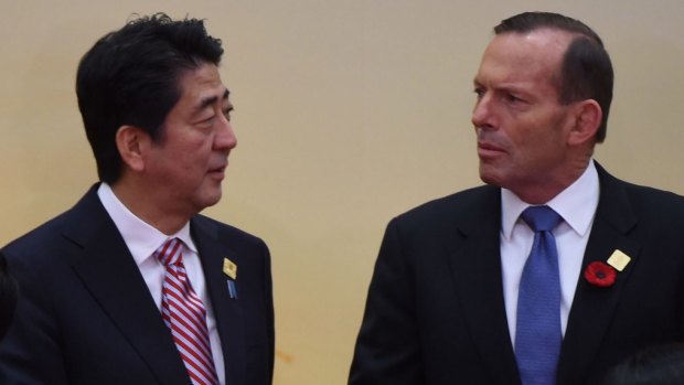 Defence purchases discussed: Prime Minister Tony Abbott chats with Japanese Prime Minister Shinzo Abe at the East Asia Summit in Myanmar.