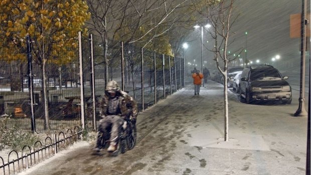 A man in a wheelchair makes his way to the homeless shelter in Salt Lake City as a major storm blows into Utah.