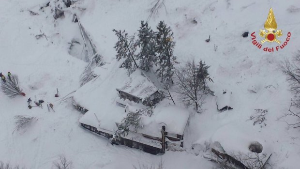 An aerial view shows the hotel Rigopiano buried by snow.