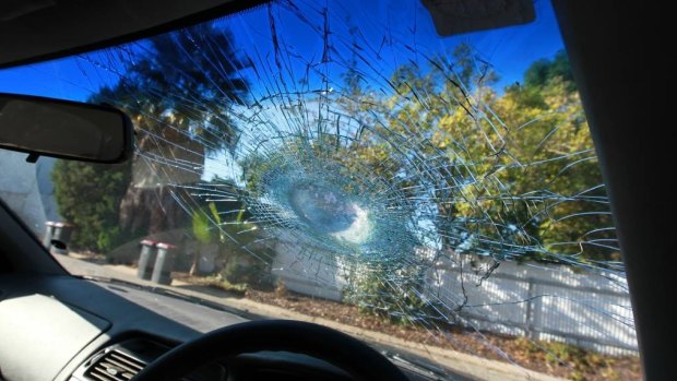 The smashed windscreen of the car.